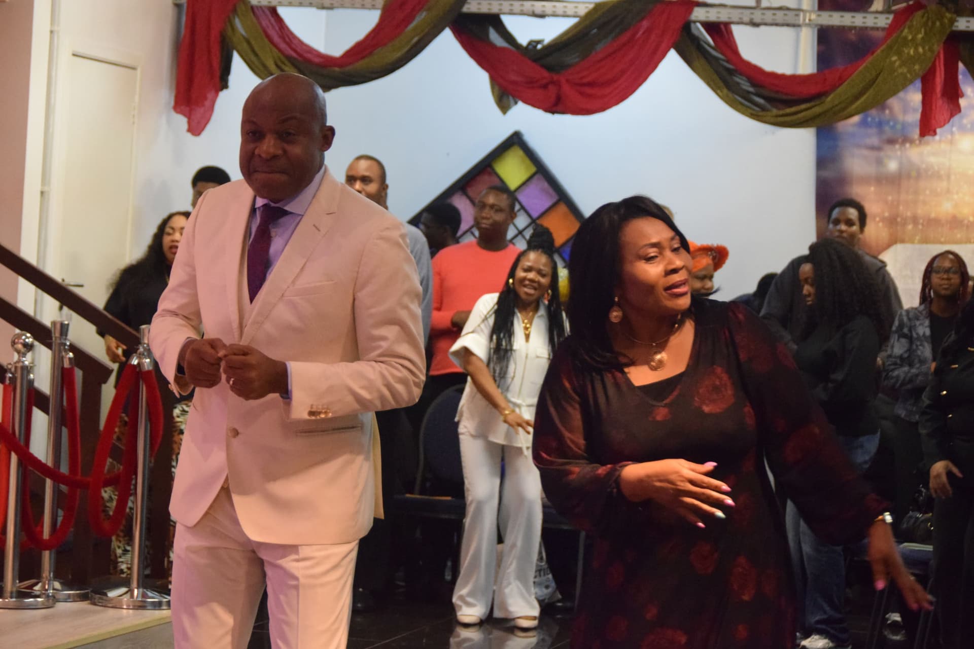 The pastors dancing at the front of the church during a celebration service