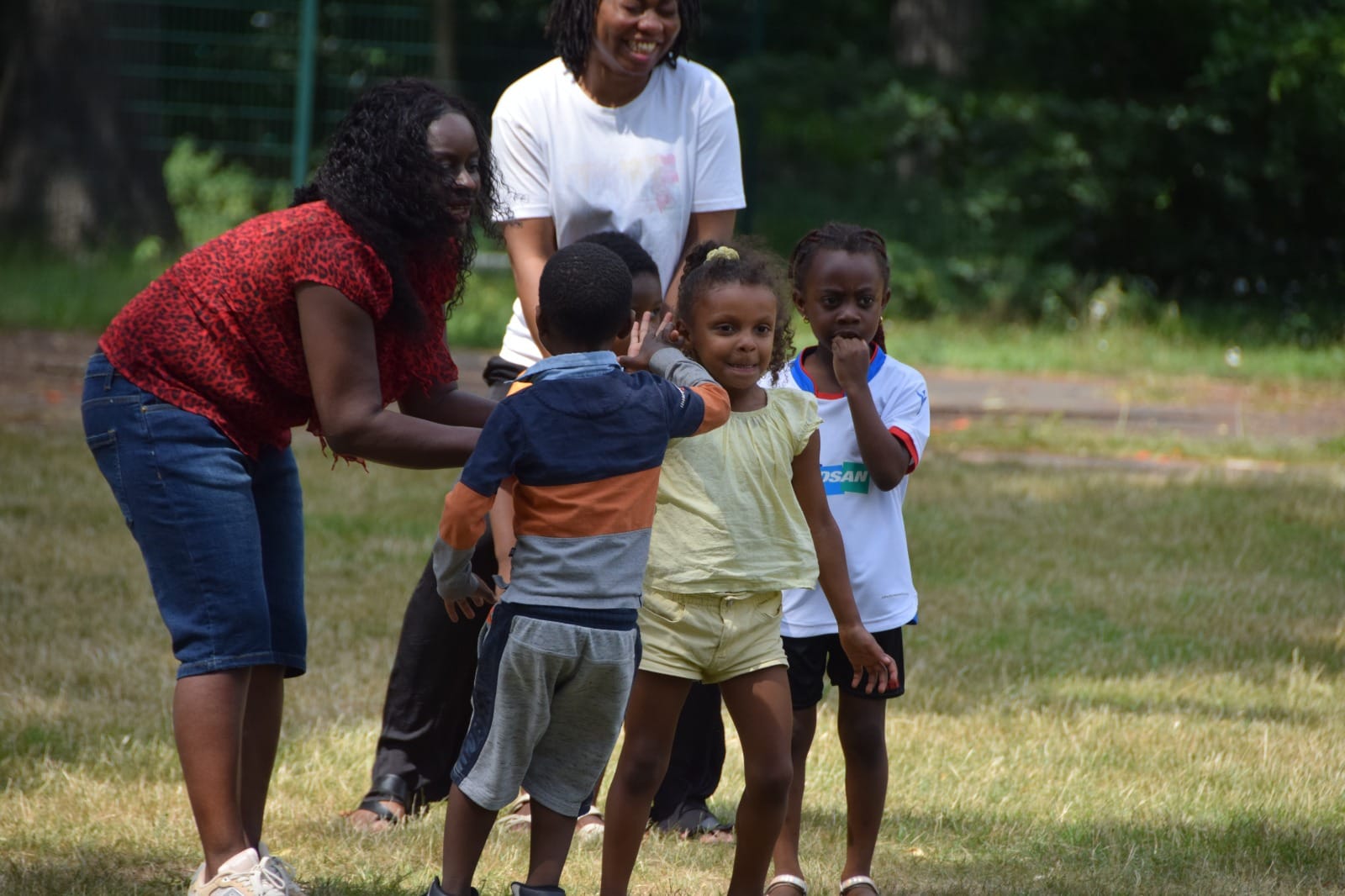 Children racing through a hoop game on an outing