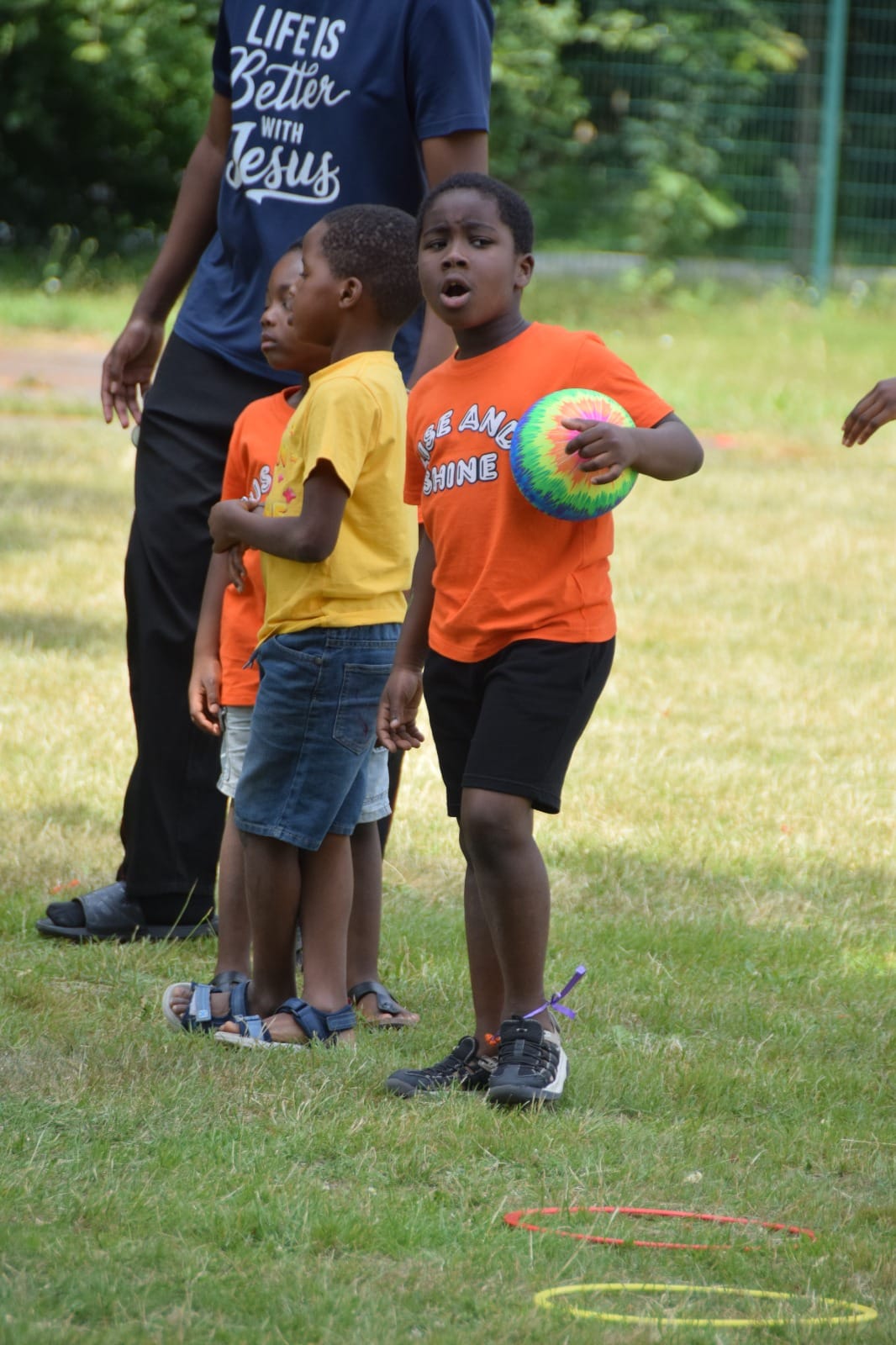 A boy holding the ball during games on an outing