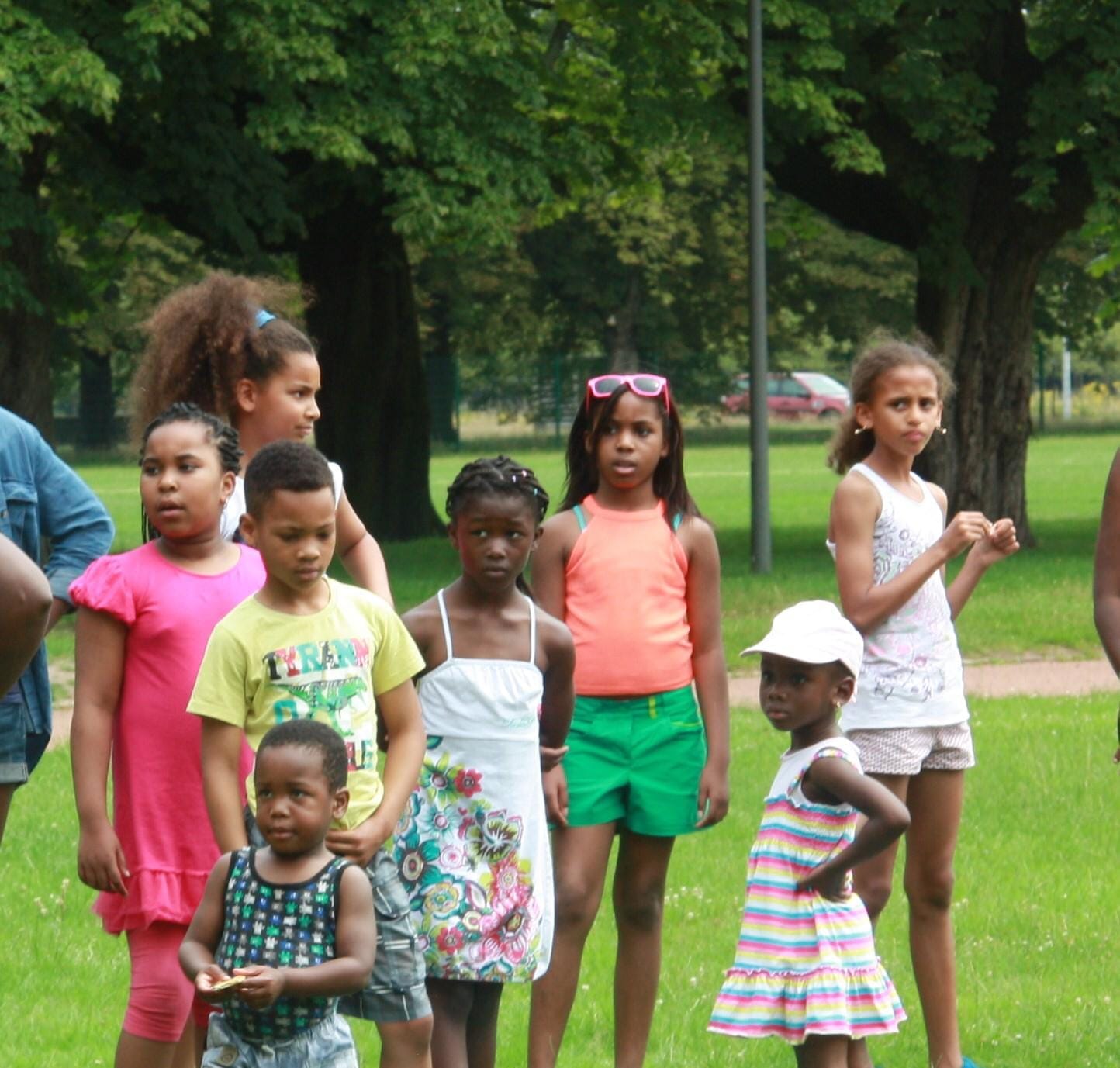 Children lined up on the grass for games on an outing