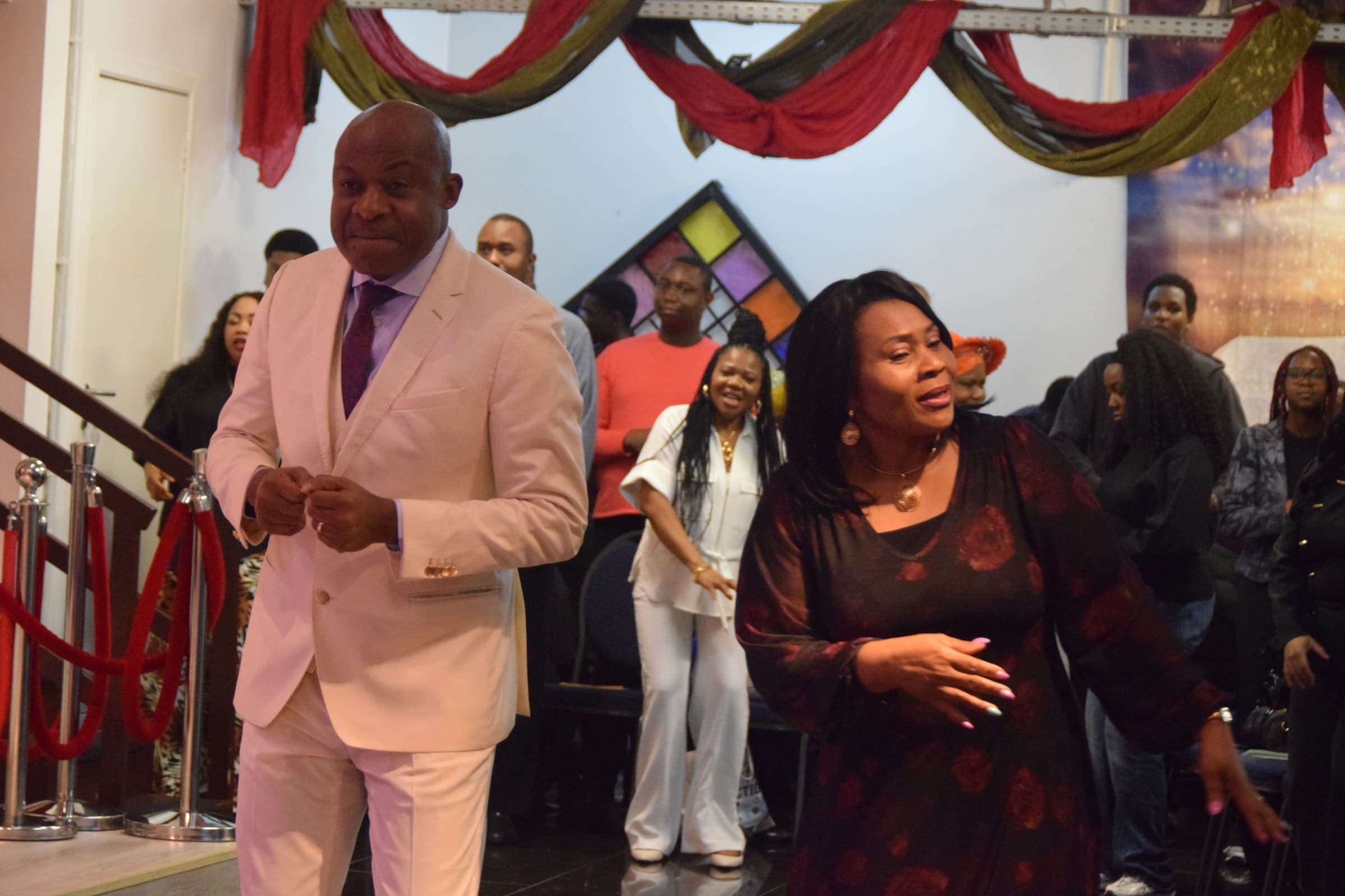 The pastors dancing at the front of the church during a celebration service