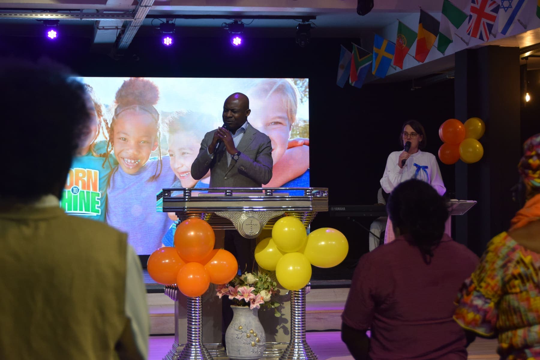 A minister speaking at the podium during the children’s presentation