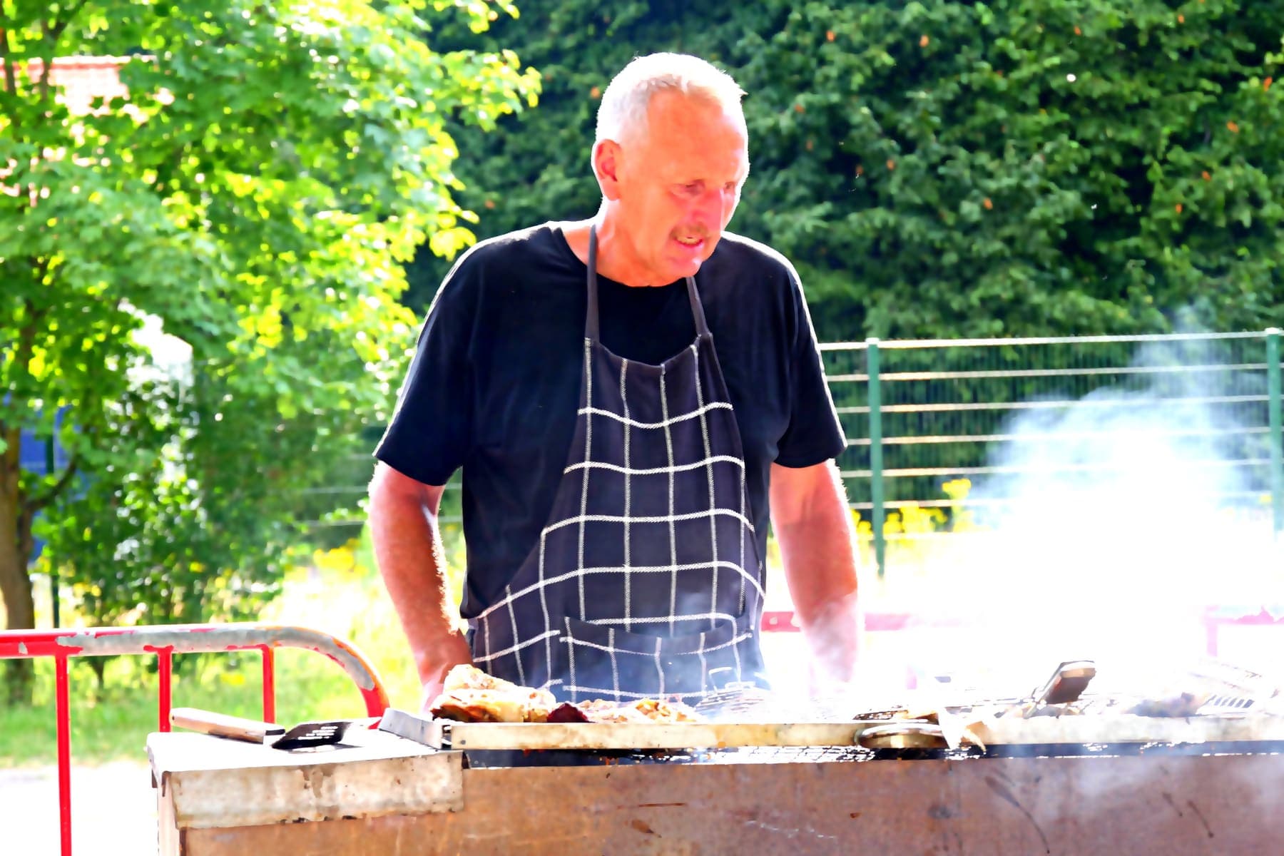 A member tending the grill at the church barbecue
