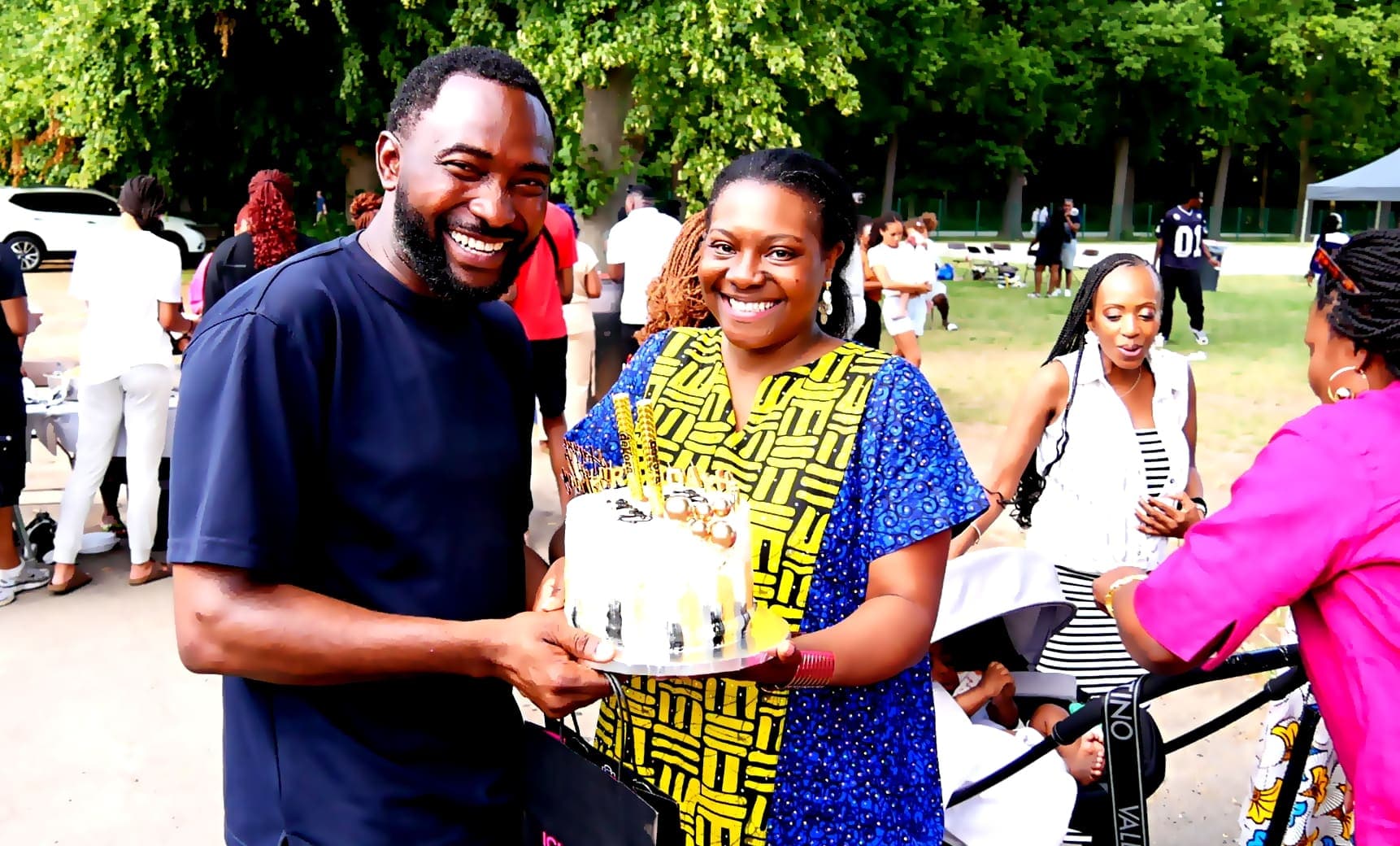 Two members presenting a cake at the barbecue