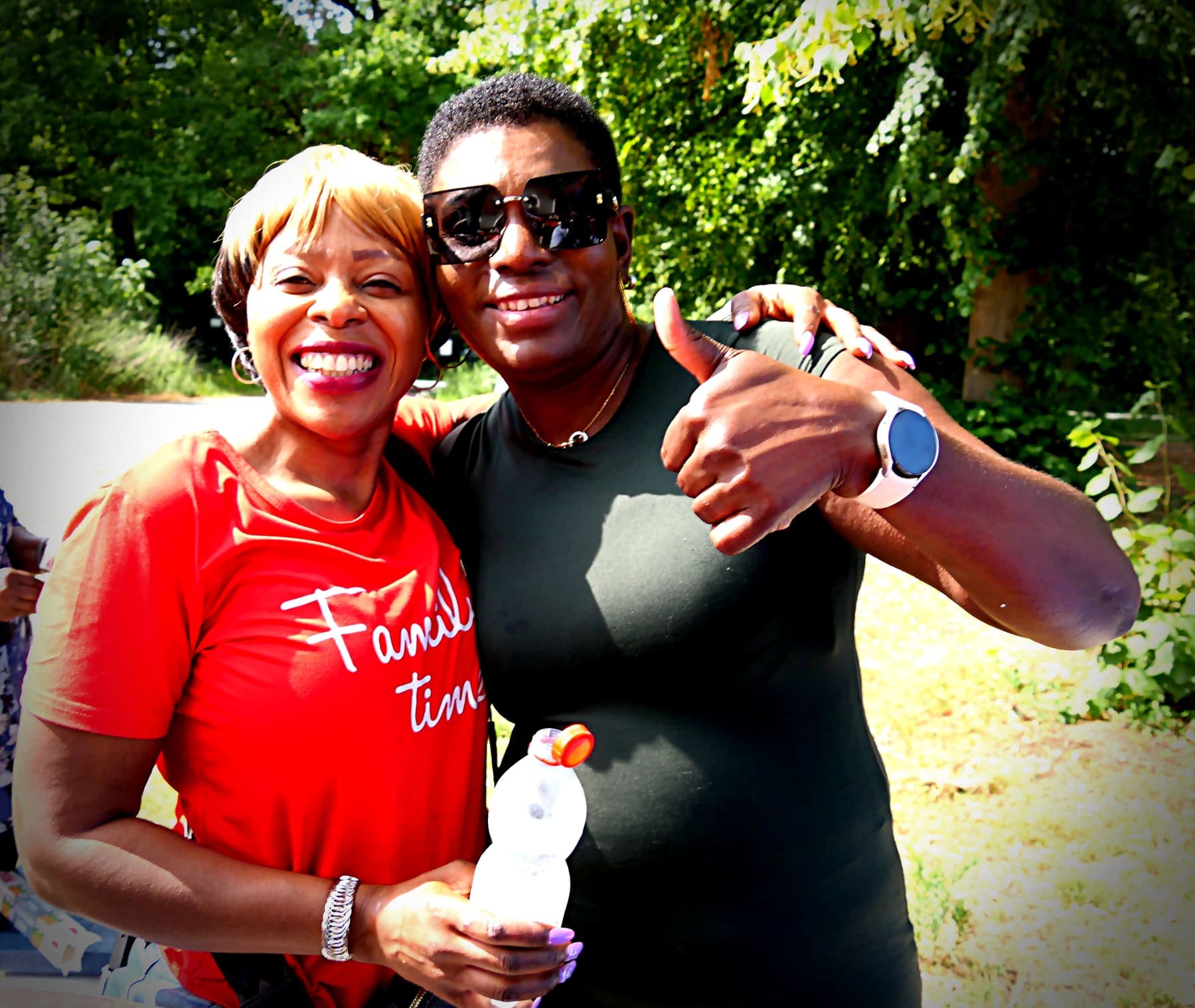 Two members standing together at the summer barbecue