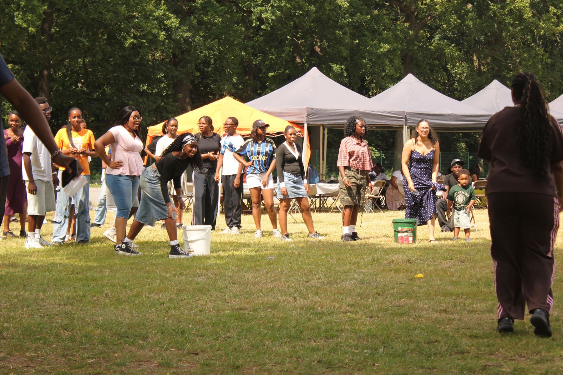 Members walking between the gazebos at the barbecue