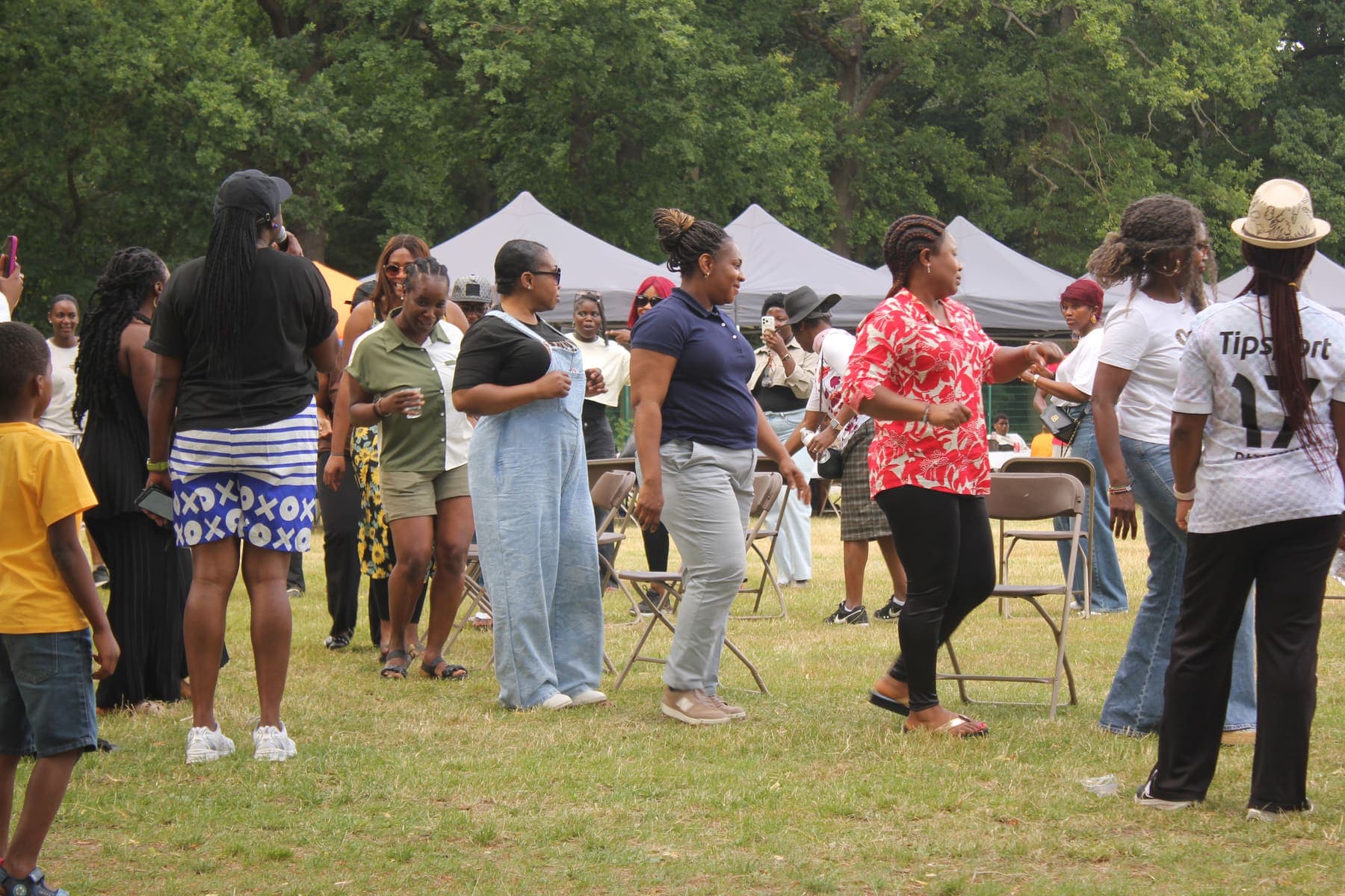 Members dancing together outdoors at the barbecue