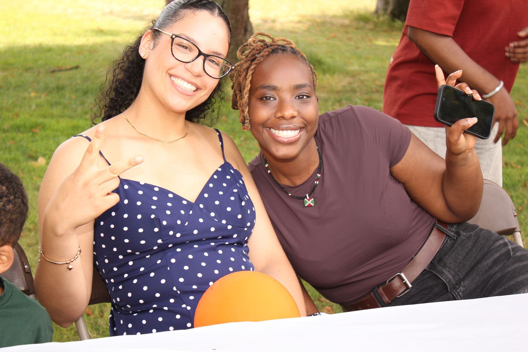 Two members sitting together at the barbecue