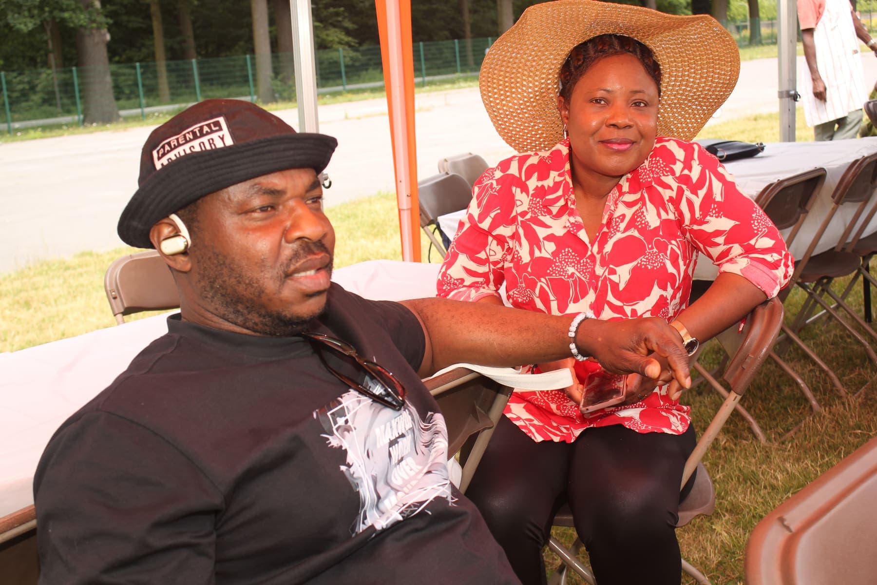 A couple seated together at the barbecue