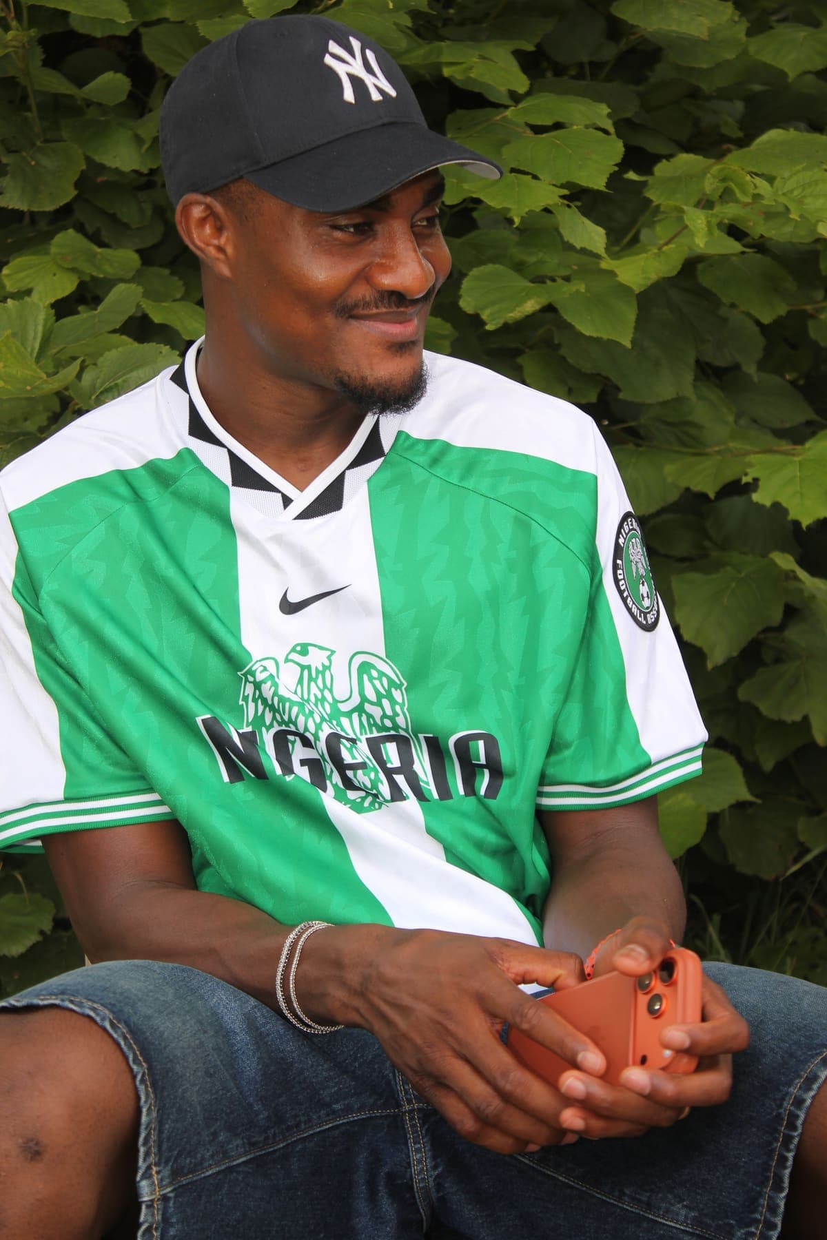 A member seated with a football at the barbecue