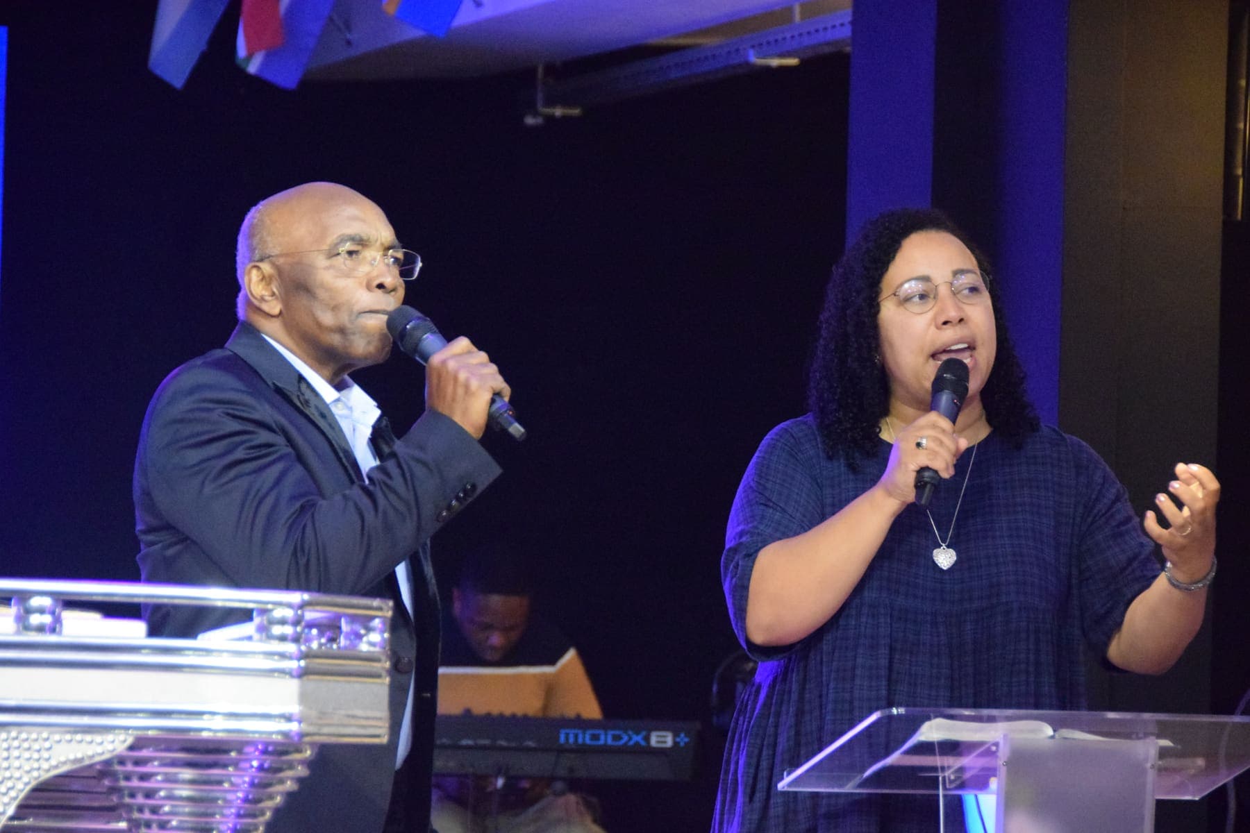 Two members leading worship with microphones