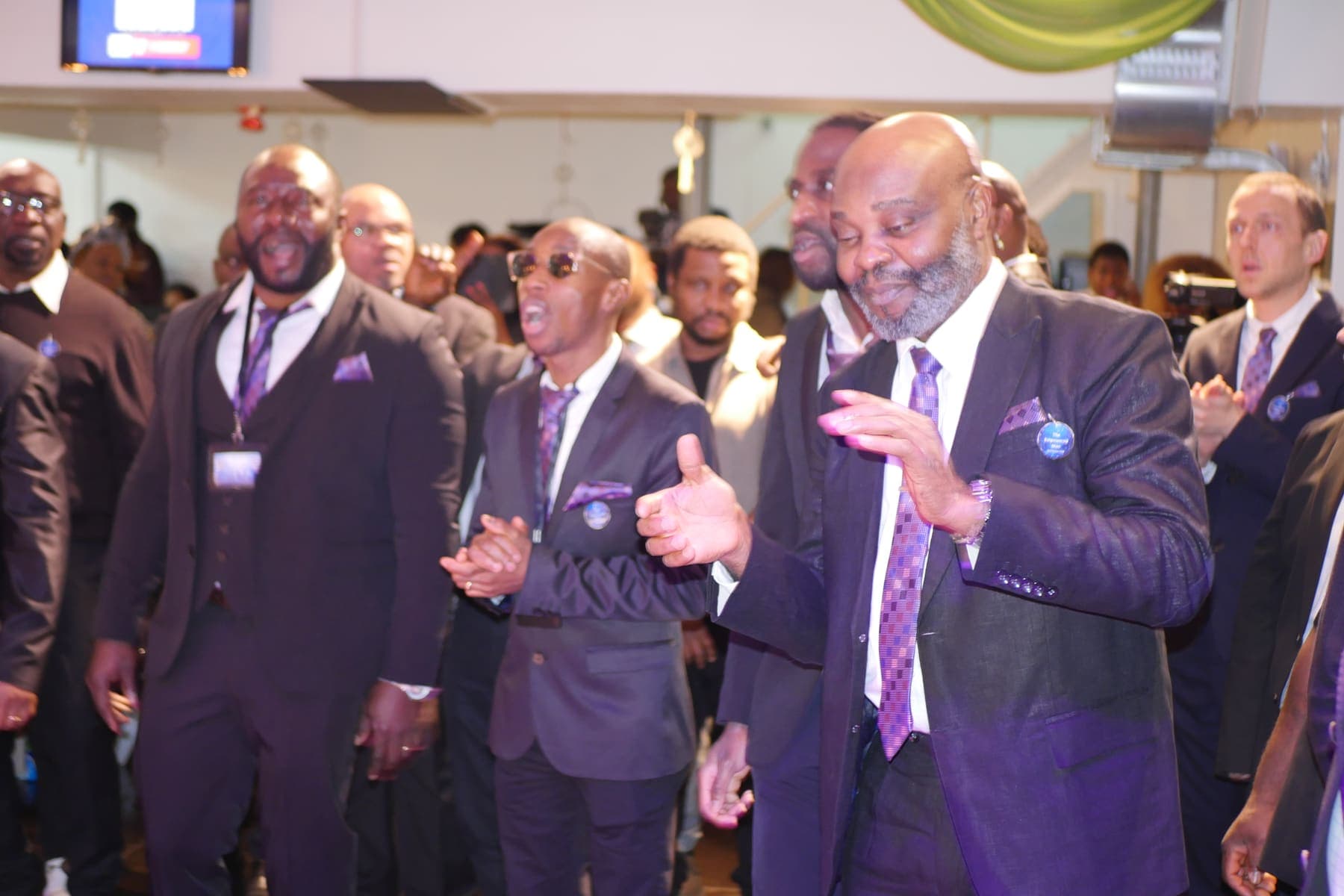 Men singing together during the Men’s Day celebration