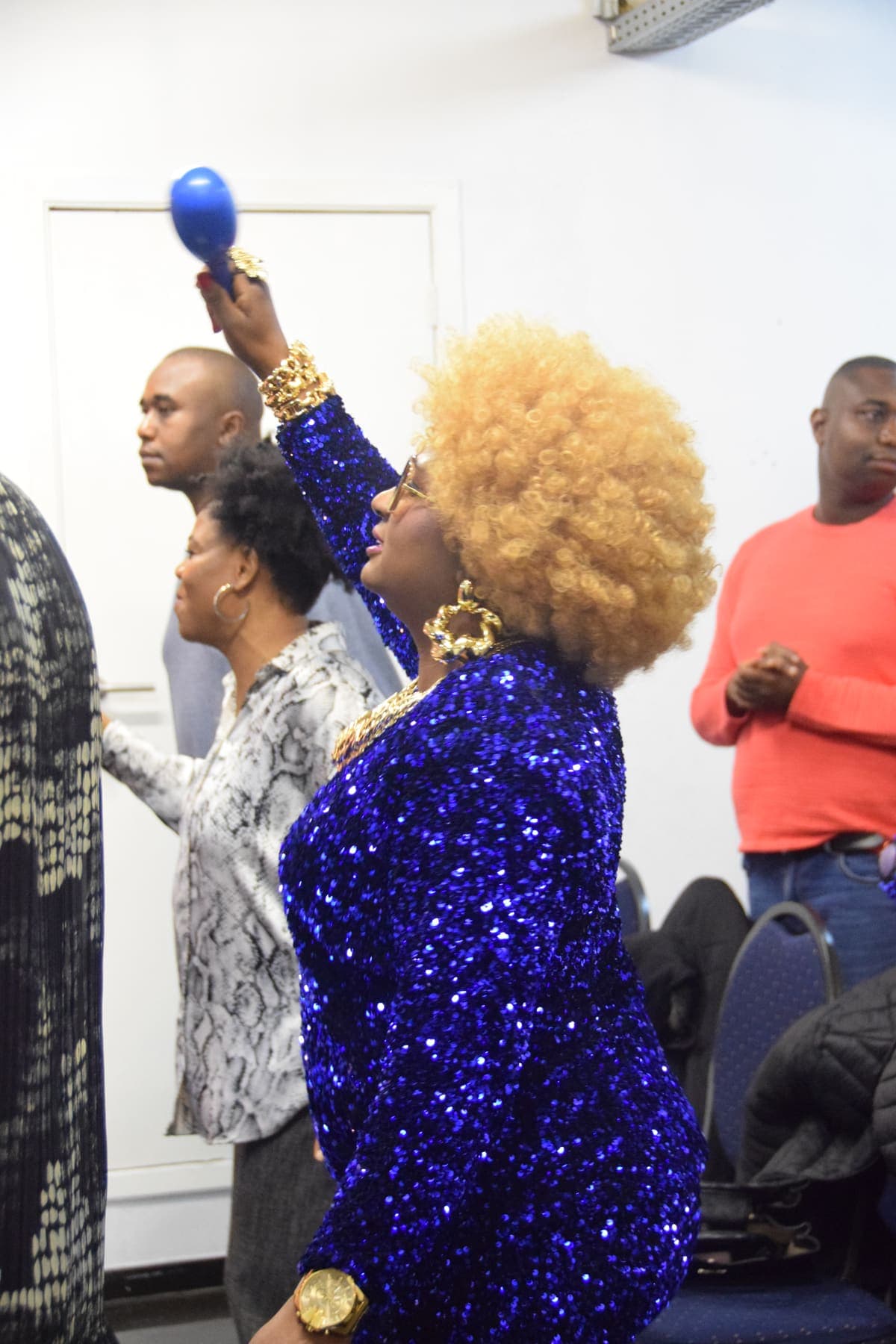 A member worshipping with a shaker during the thanksgiving service