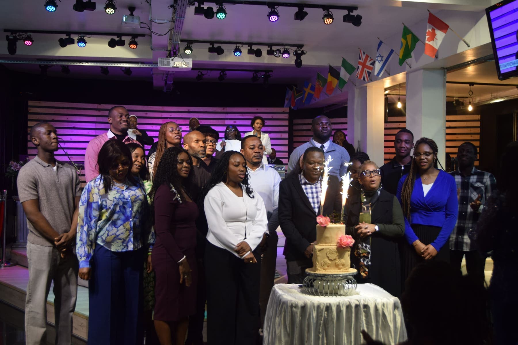 Members gathered around the thanksgiving cake