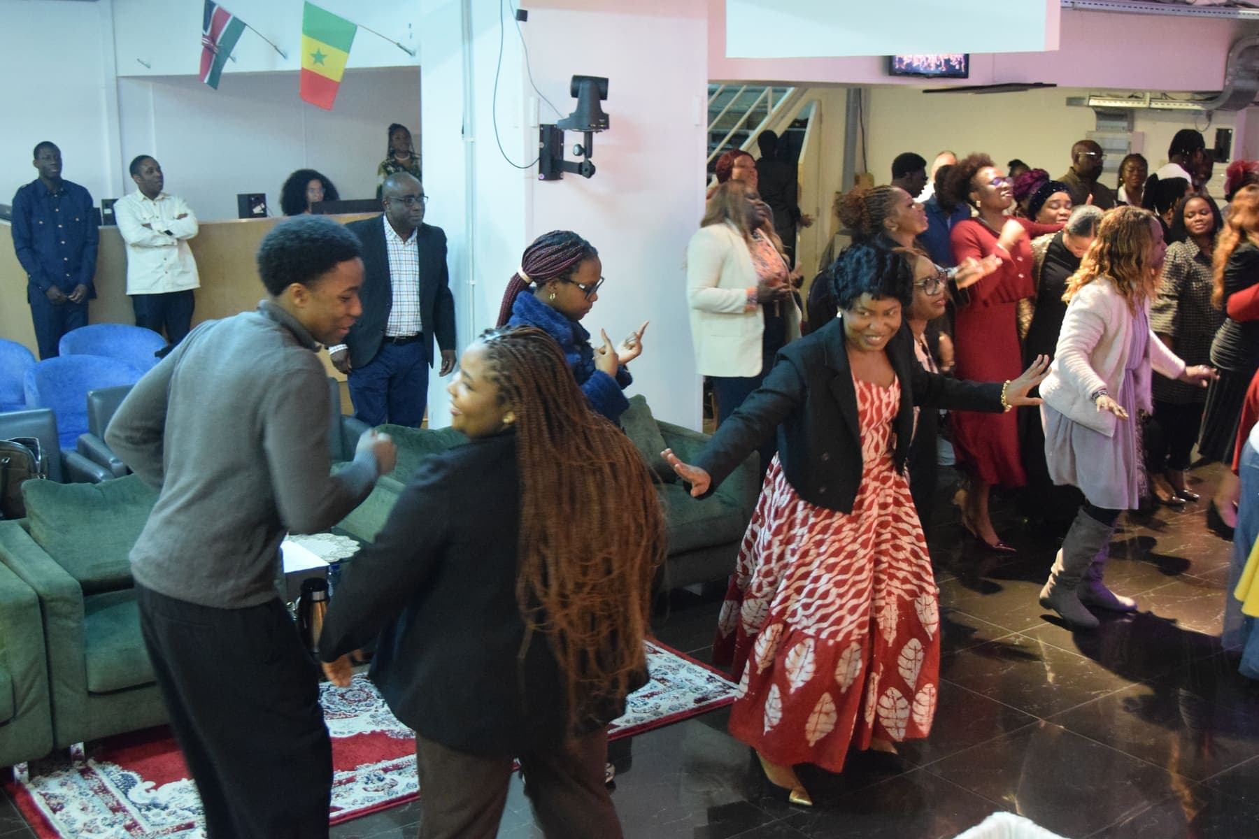 A wide view of the congregation dancing at the thanksgiving celebration